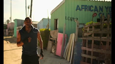 african american male boxer exercising near beach in sunshine 4k