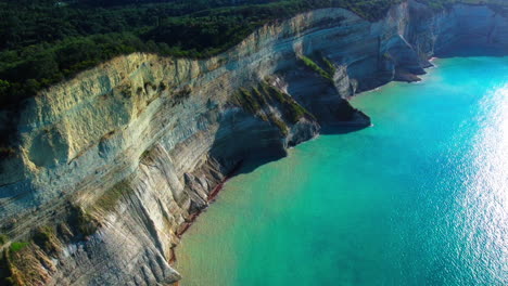 Flight-over-high-cliffs-of-sea-coast,-aerial-view