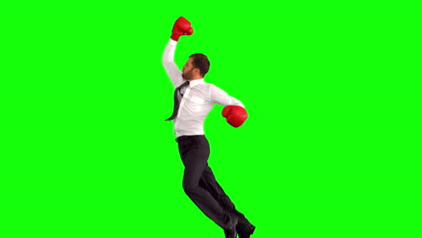 businessman leaping with boxing gloves and punching