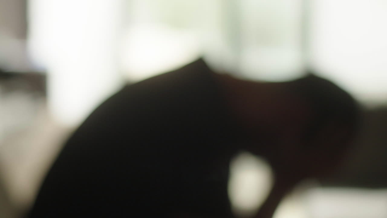 Blurred image of a person appearing sad.