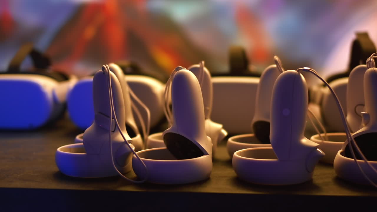 Virtual reality VR equipment on a table. VR headsets and joysticks