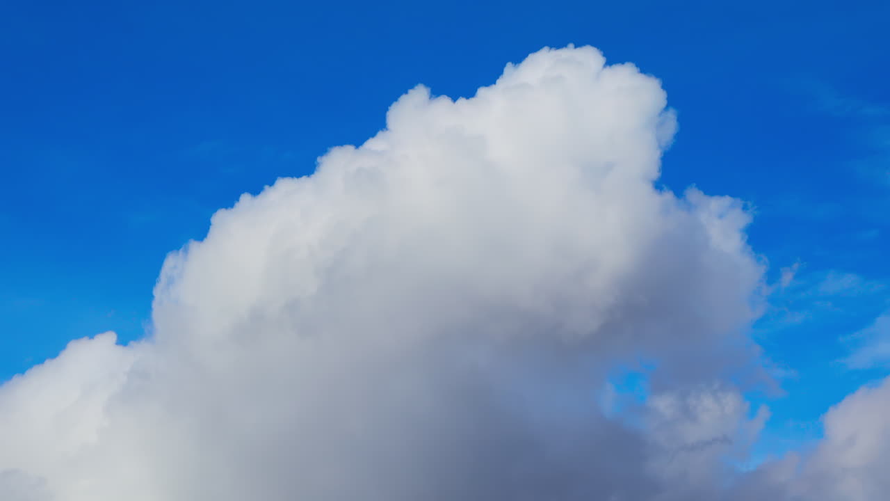 View of white clouds, fluffy moving on the blue sky