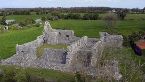 Slow-orbiting-shot-of-Annaghdown-Abbey-on-a-quiet-sunny-day