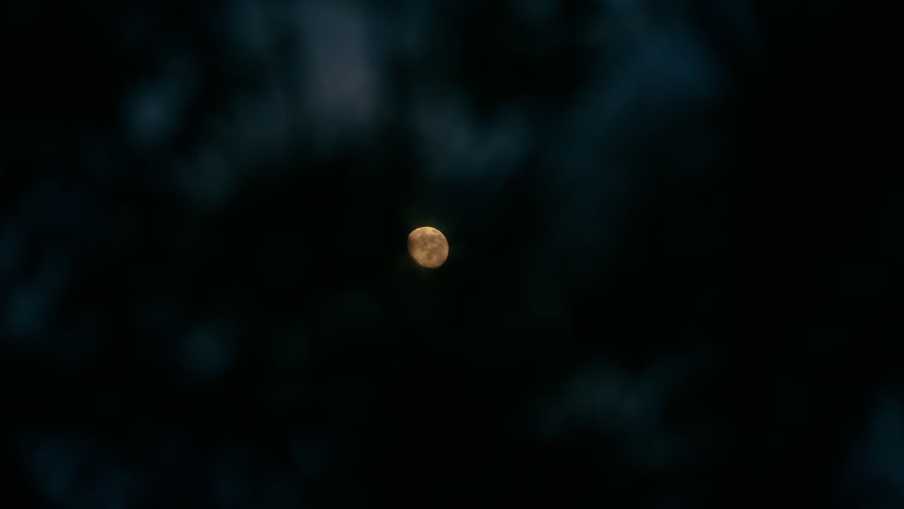 Full Moon Behind the Clouds at Night