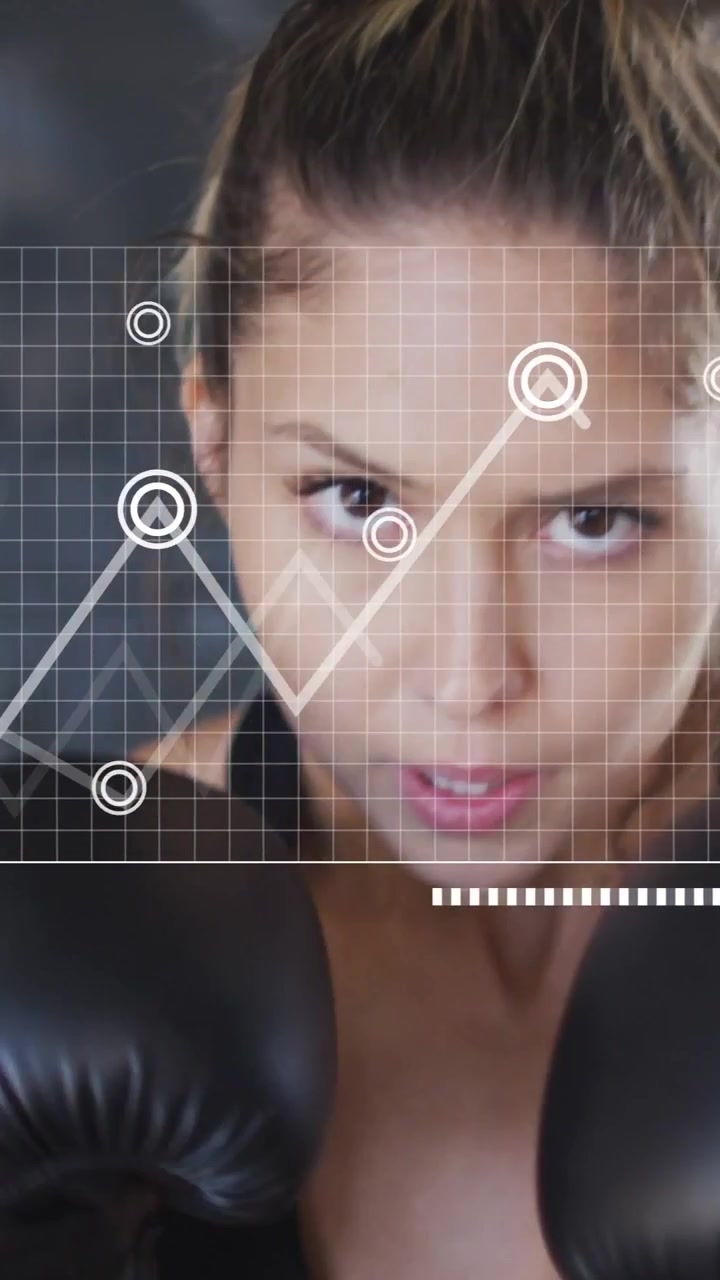 Vertical video: Woman boxer raising gloves and starting HUD, plots and charts tracking fitness data