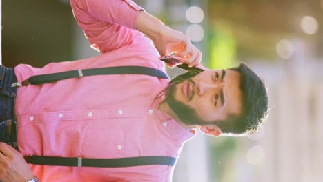 bearded man talking on smartphone