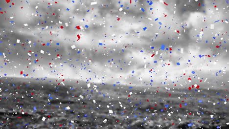 animation of american red, white and blue confetti falling over black and white cloudy sky and field