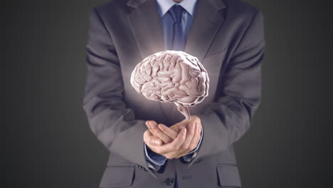 Businessman-presenting-brain-with-hands