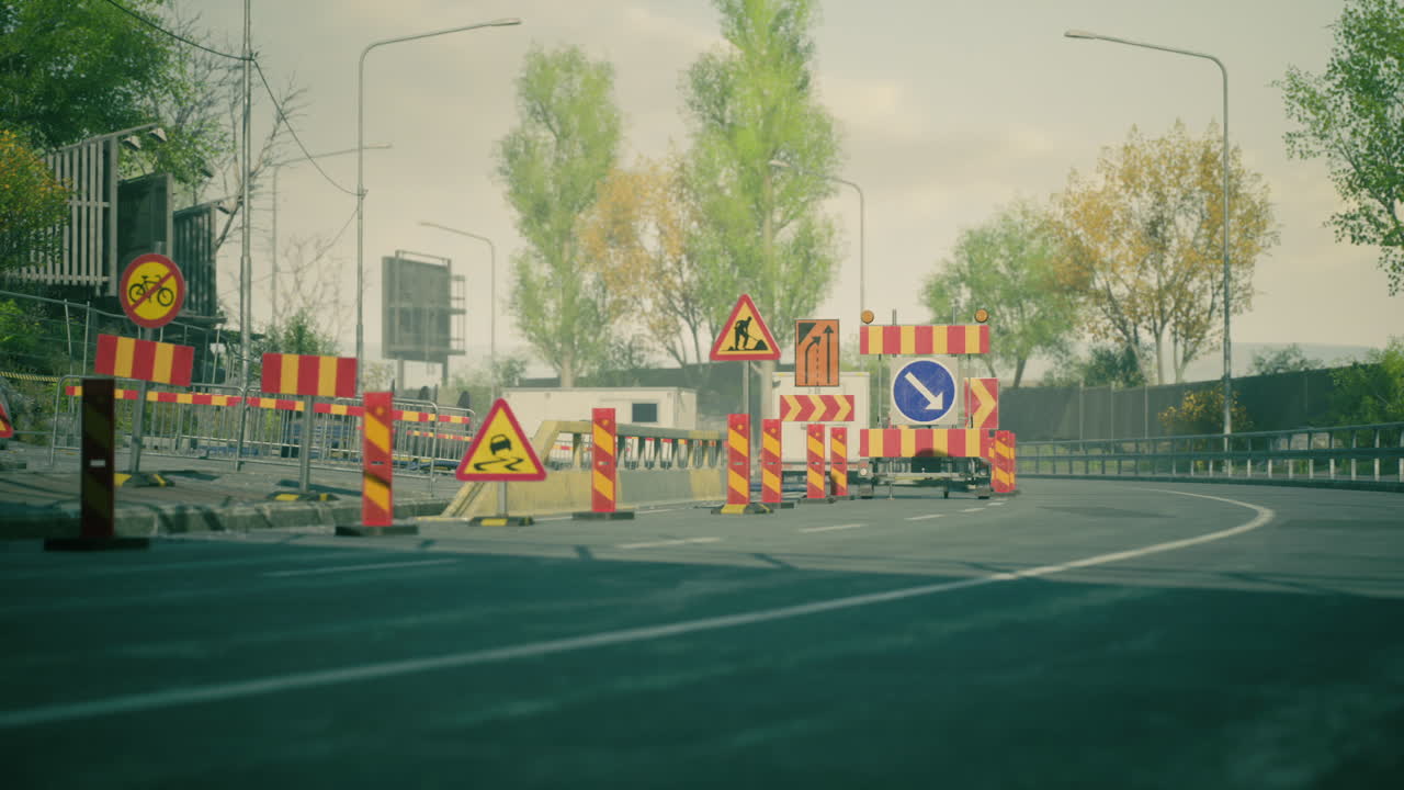 Road construction with warning signs and barriers in an urban setting