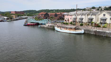 old boat moored with riverside houses bristol city uk aerial footage