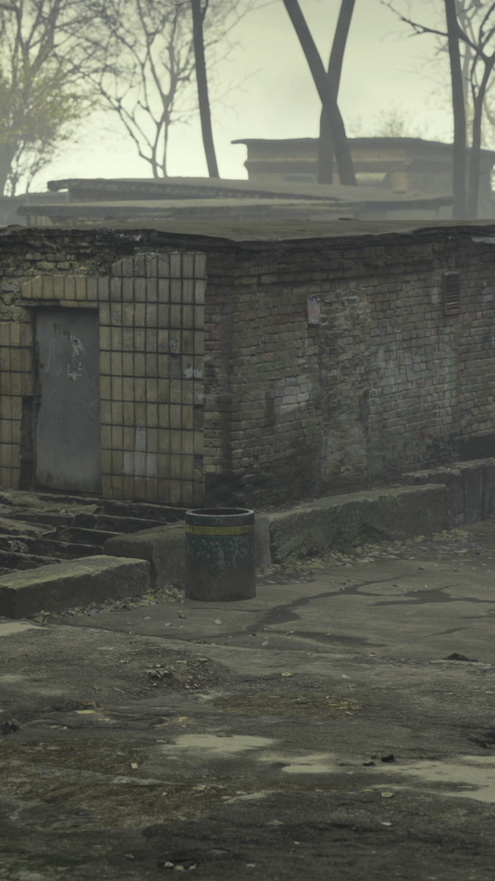 Old building with worn steps and a trash can on a foggy day
