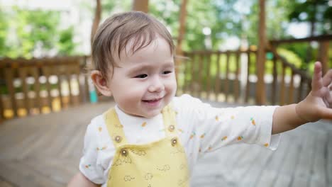 cheerful mixed race baby girl waving her hand