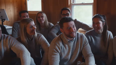 happy group of friends gathered in a cozy wooden room