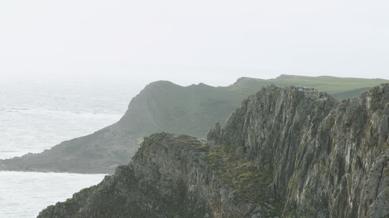 Dramatic Coastal Cliffs with Hazy Sea Background on Gower Coast Path Wales UK 4K