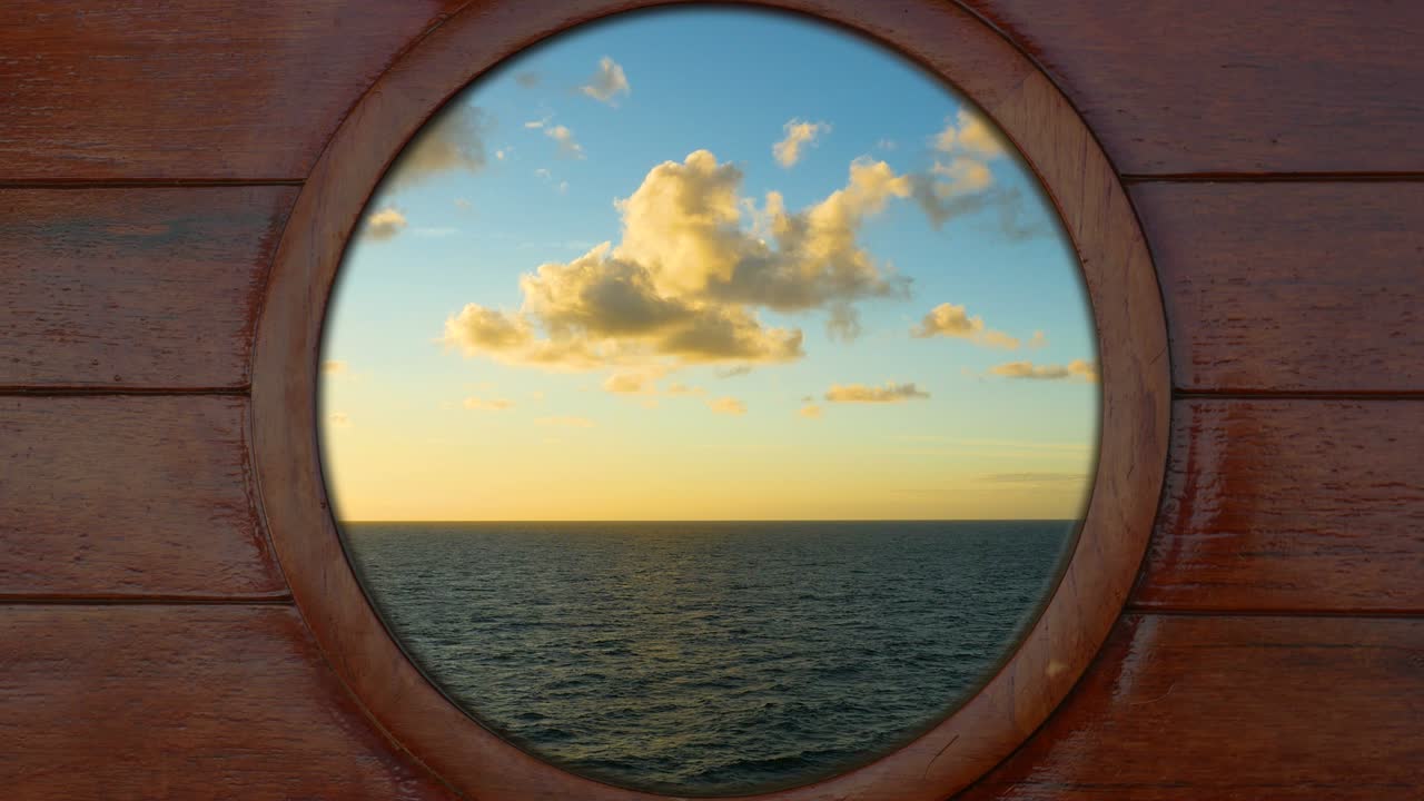 Looking outside through a porthole of a cruise ship to the sea