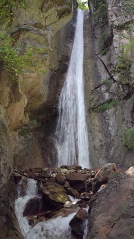 a wild waterfall cascades down a rocky slope near kaltern - caldaro, south tyrol, italy