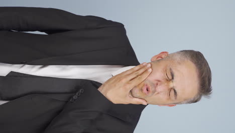 vertical video of businessman suffering from toothache.