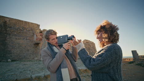 smiling guy holding camera making vacation pictures closeup. carefree newlyweds