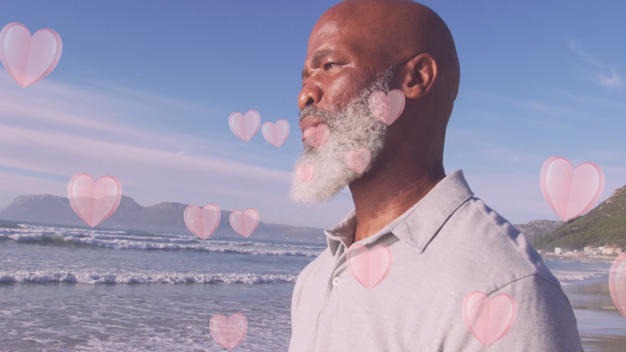 animación de los corazones sobre el anciano hombre afroamericano en la playa
