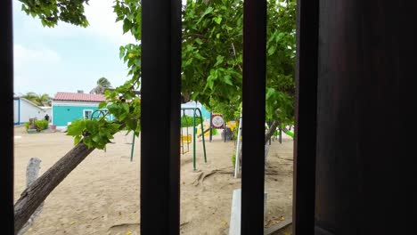 Wooden-Window-Overlooks-Playful-Paradise,-Colonial-architecture-Caribbean-Venezuela