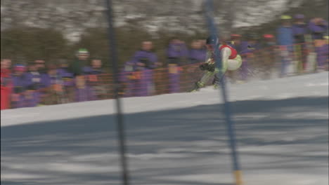 a skier races through a down hill slalom