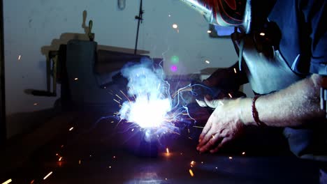 Welder-working-on-a-piece-of-metal