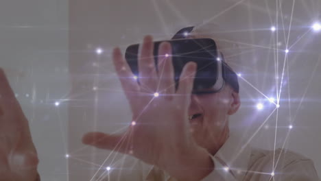 animation of network of connections over businessman using vr headset