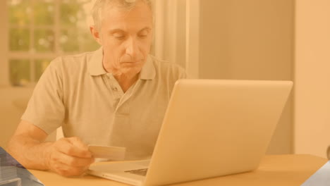 animation of shapes over caucasian man using laptop for online shopping