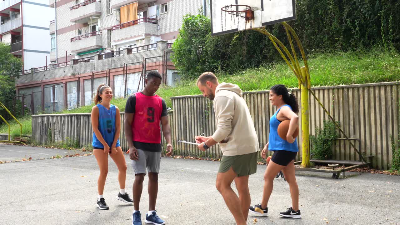 People playing basketball outdoors