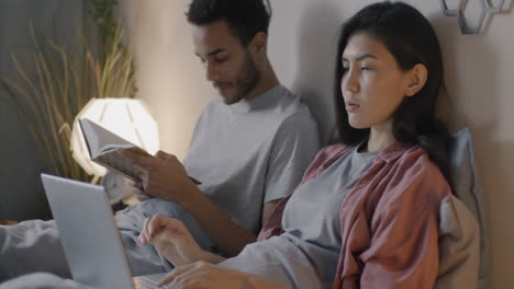 couple relaxing in bed at night