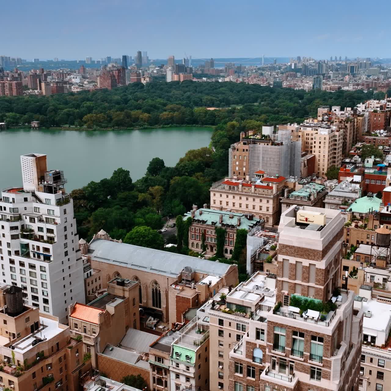 Densely built architecture around Central park of New York. Amazing cityscape of metropolis on sunny daytime. Top view
