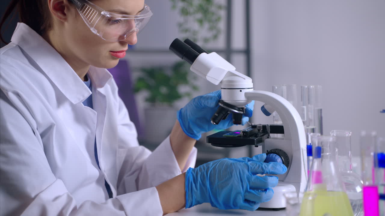 Female Scientist Using Microscope in Laboratory
