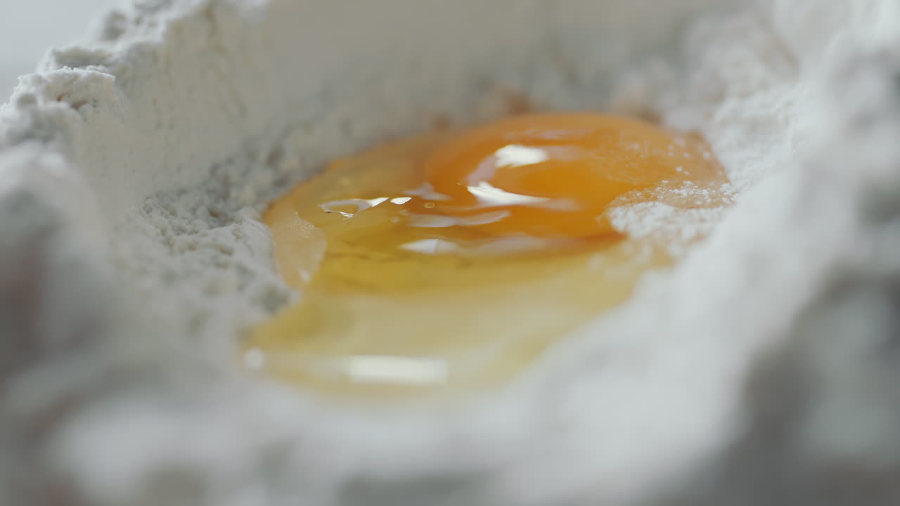 Pouring Egg in Flour Mound
