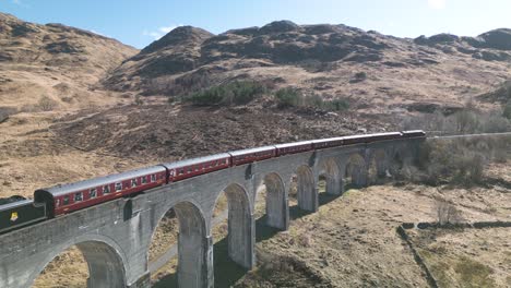 aerial pullback reveals amazing steam engine train on famous viaduct