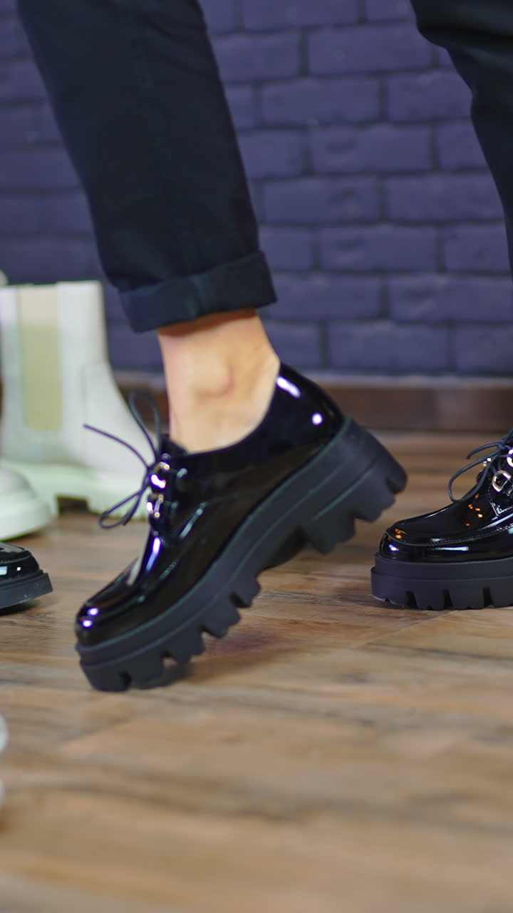 Fashionable casual style for females. Jacket, jeans, white sneakers and black leather bag. Studio footage. Vertical video