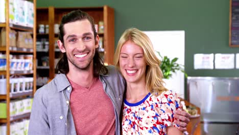 Happy-couple-standing-in-supermarket