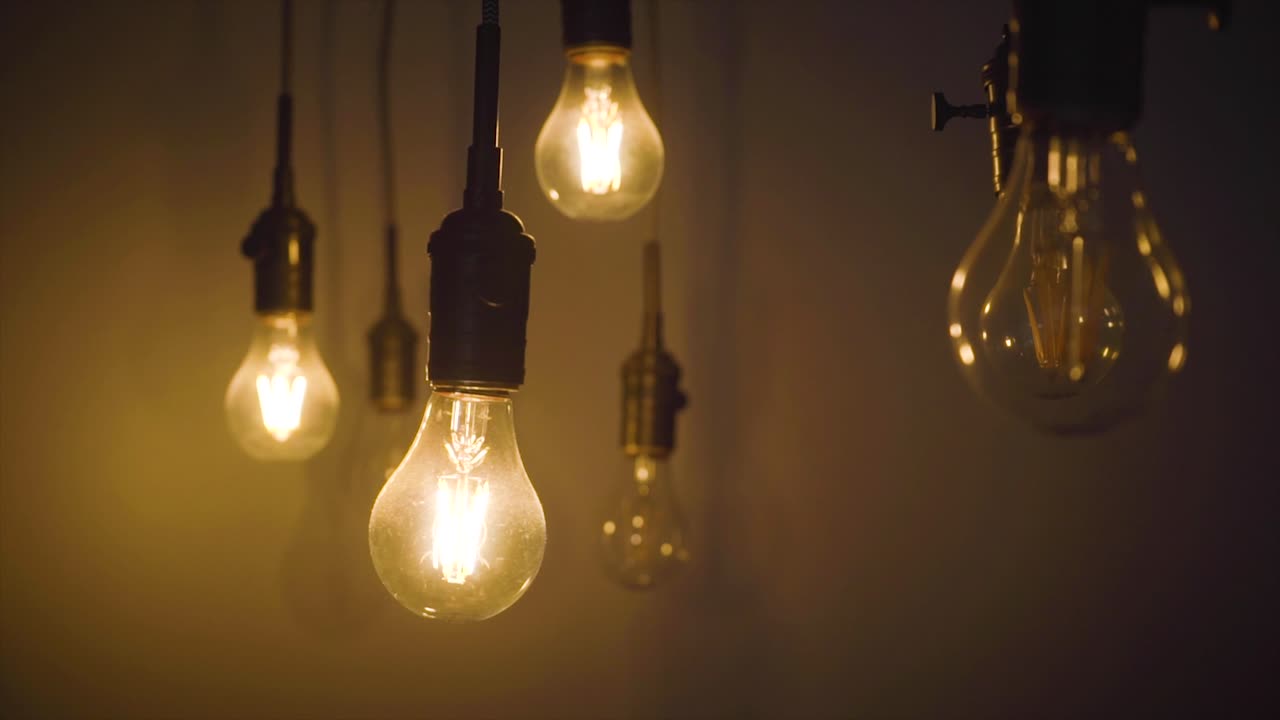 Light bulbs in an office environment in slow motion.