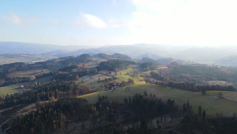 aerial view of a natural landscape full of hills and forests around during a sunny day