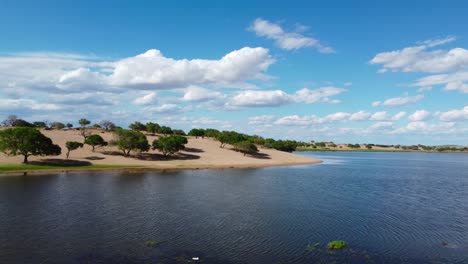 Wunderschöner-See,-Umgeben-Von-Land-Mit-Bäumen-In-Der-Graslandwüste