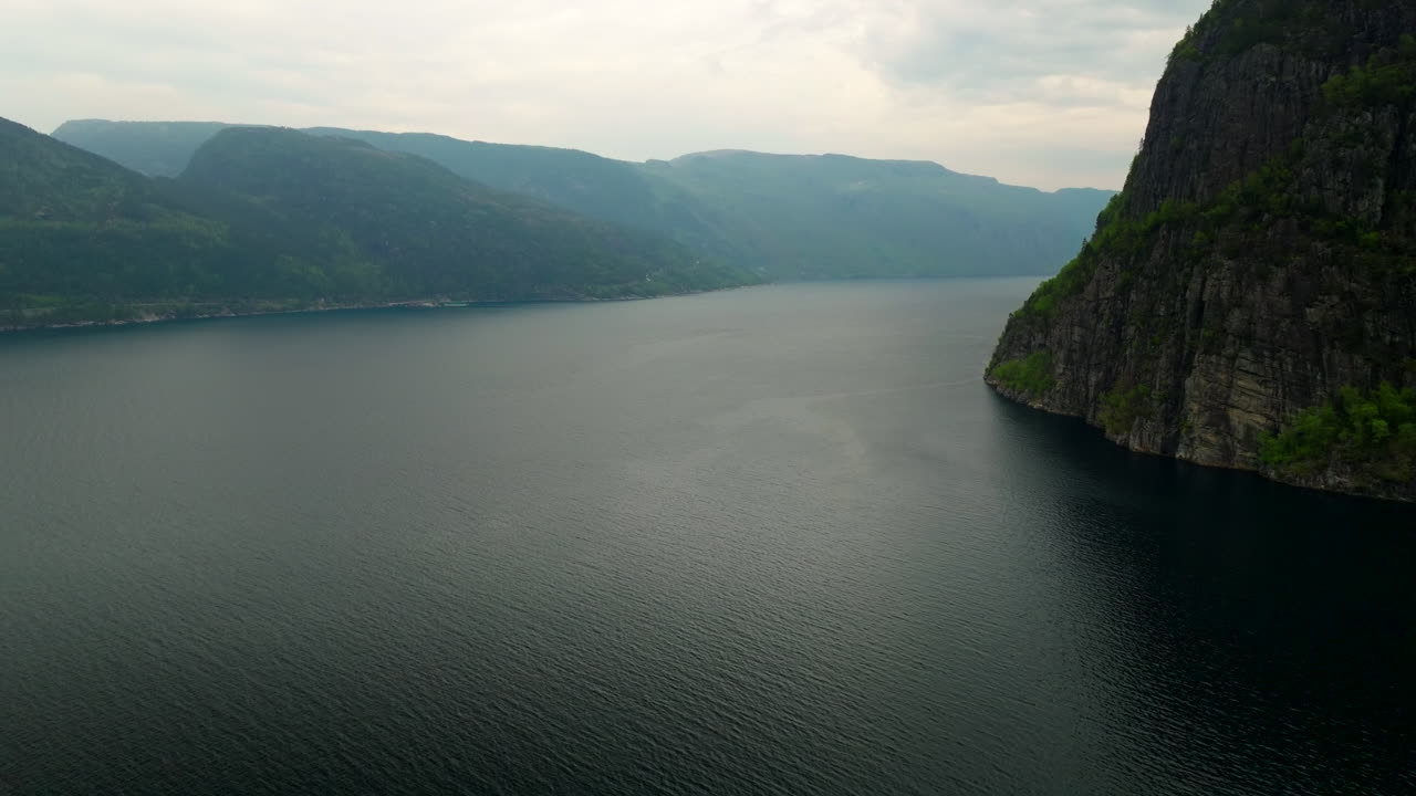 Aerial view, Jøsenfjord in Norway with steep cliffs, calm waters, and dramatic mountain scenery, showcasing the beauty of Scandinavian nature