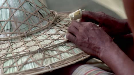 indian craftsman master weaves hat from wooden sticks rural village lifestyle