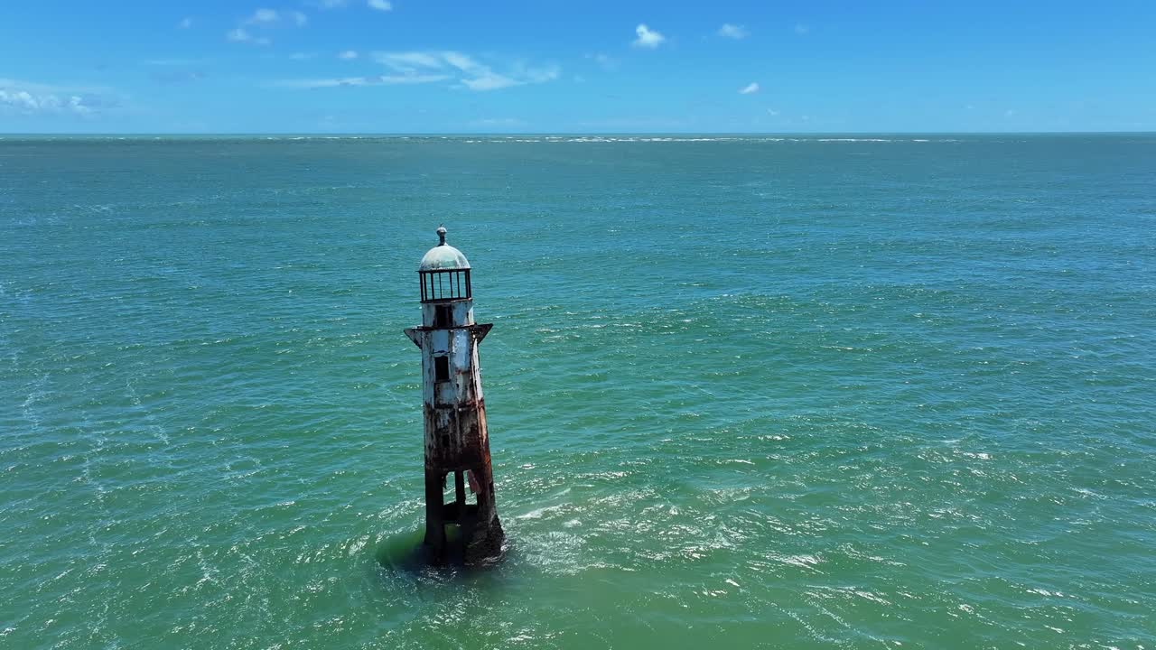 Drone view of ruined lighthouse where the São Francisco River meets the Atlantic Ocean
