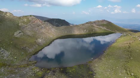 mountain lake at seven rila lakes in bulgaria - aerial 4k circling