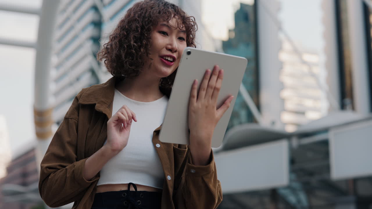 Young woman using tablet in the city