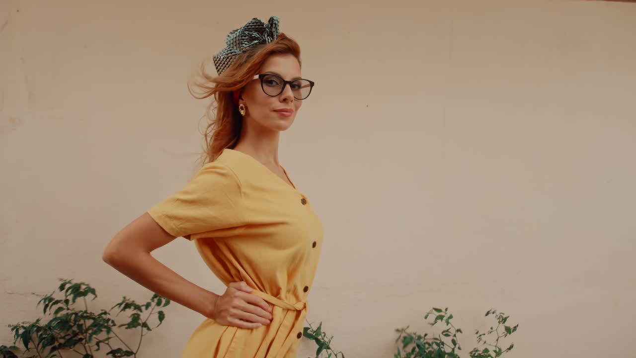 Stylish woman in yellow dress with glasses