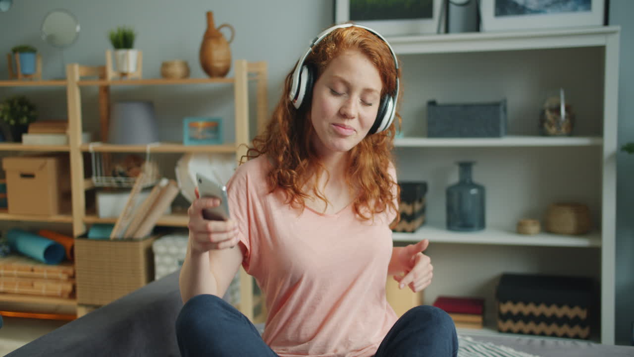 Woman Listening to Music on Smartphone at Home