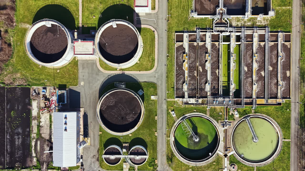 Wastewater treatment facility operates in a city providing essential services for environmental health and public safety during daylight