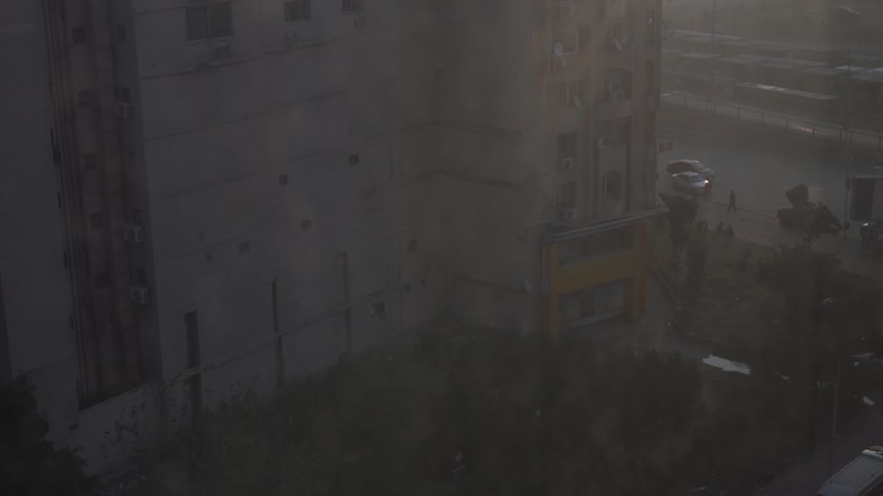 Standing on the 40th floor of the Ramses Hotel in Cairo, early morning light comes through the heavily polluted skyline