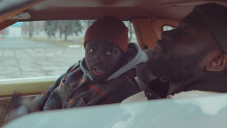 Two-Black-Men-Talking-while-Sitting-in-Car