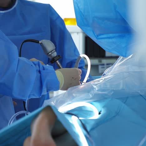 surgery operation. surgical treatment concept. medical hands performing operation with surgery tools. patient on a surgical table. close-up